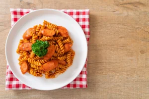 One-Pot Pastalaya with spirali pasta, sausage, and tomato sauce, garnished with fresh parsley and served in a rustic bowl.